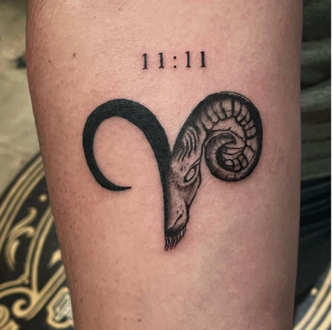 1111 with a devil sheep tattoo