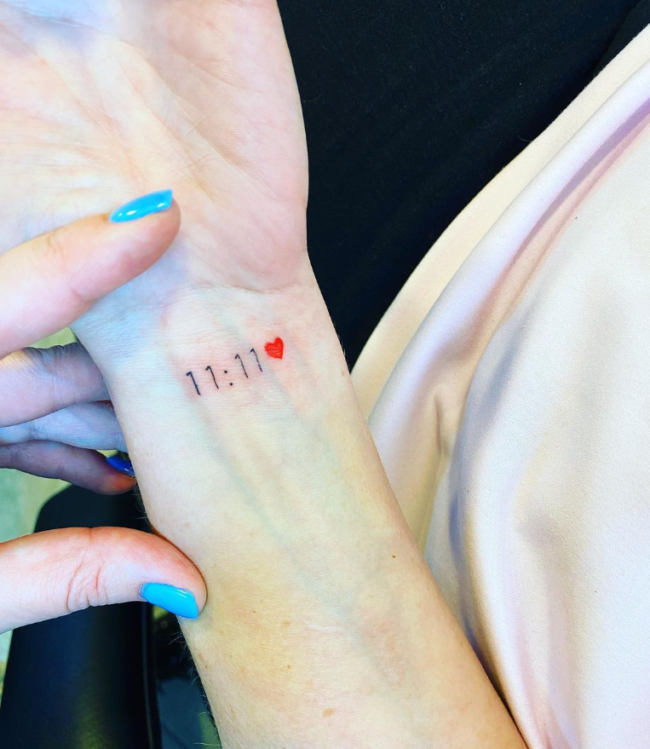 1111 with a red heart tattoo